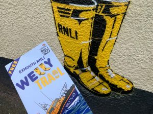 RNLI welly trail leaflet with painted yellow wellies on a wall