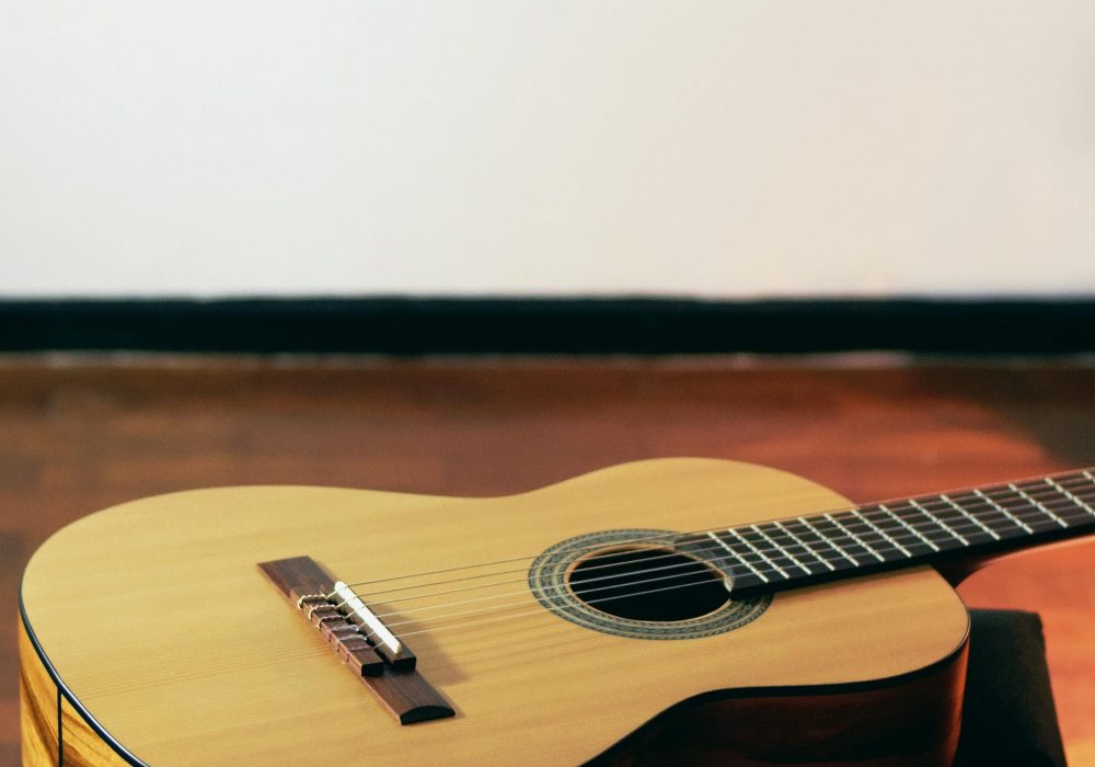A acoustic guitar lying on a table.