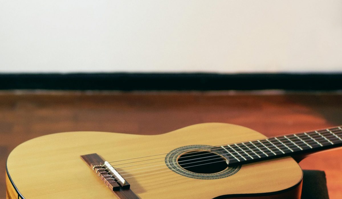 A acoustic guitar lying on a table.