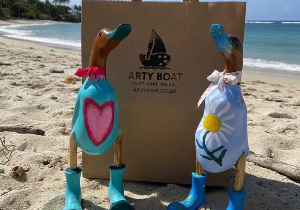 Painted wooden ducks on beach