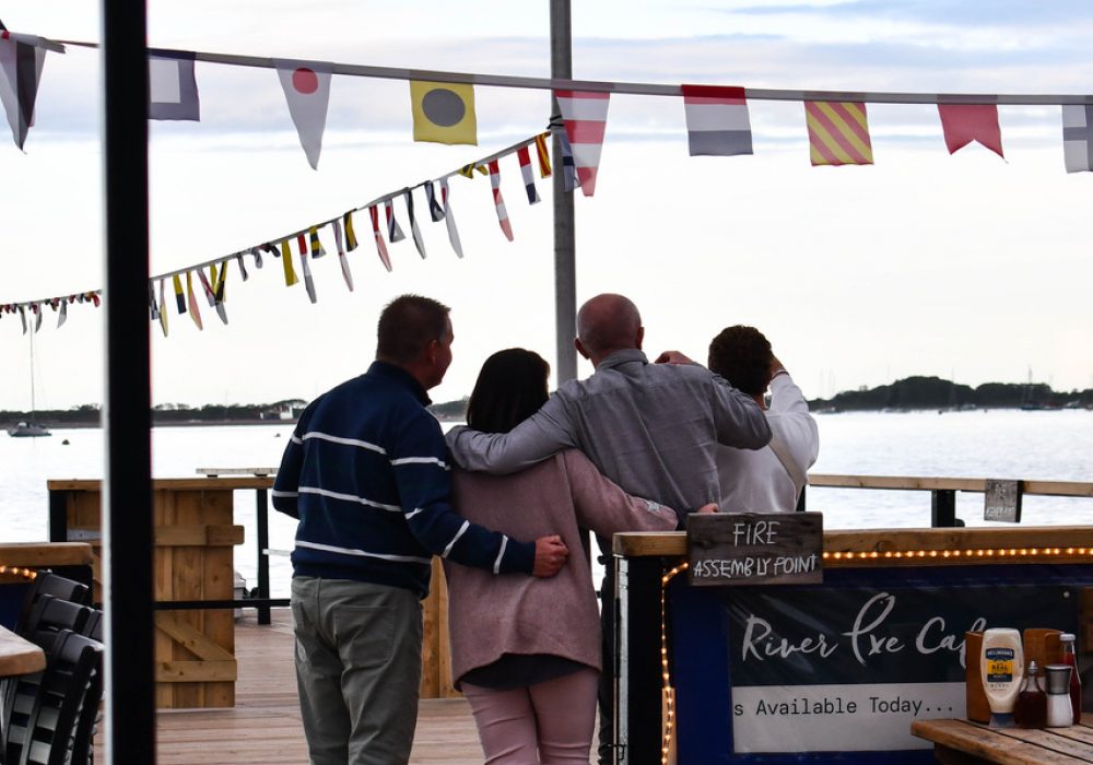 Family hugging onboard the River Exe Cafe