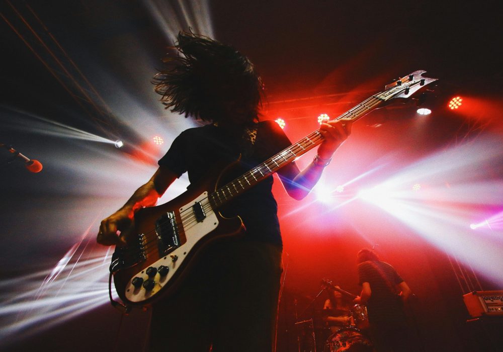 Silhouette of a man playing a rock guitar.