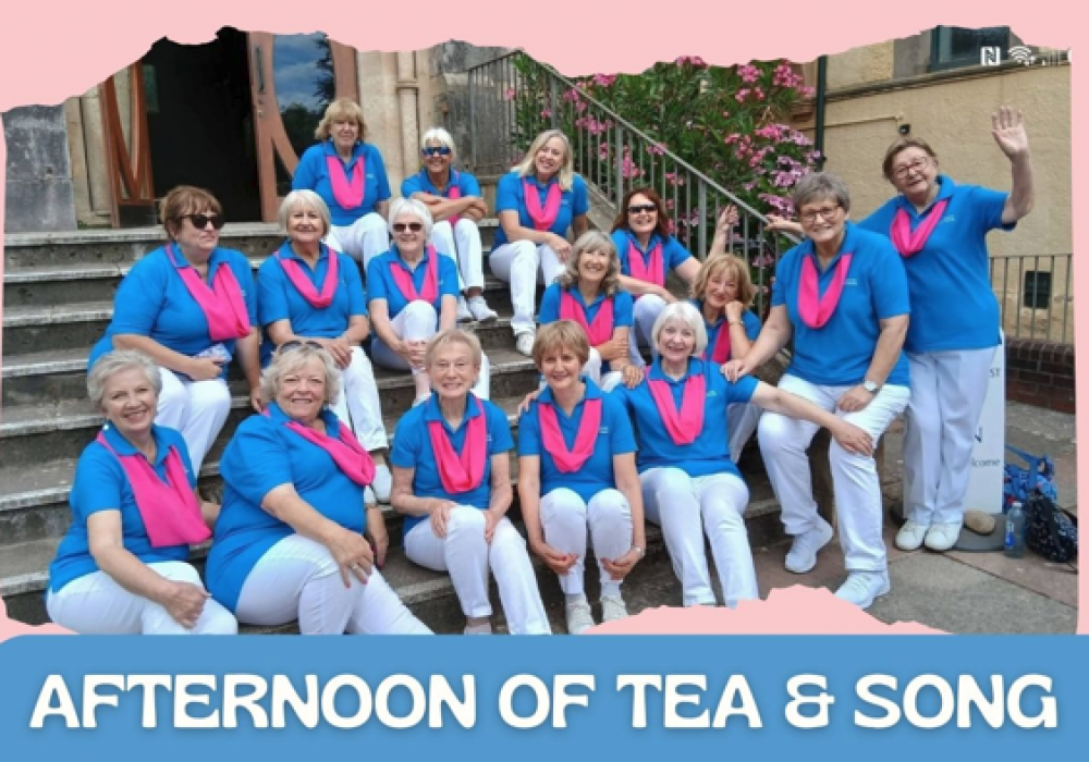 Group photo of the Exmouth A Cappella Choir members sat on steps