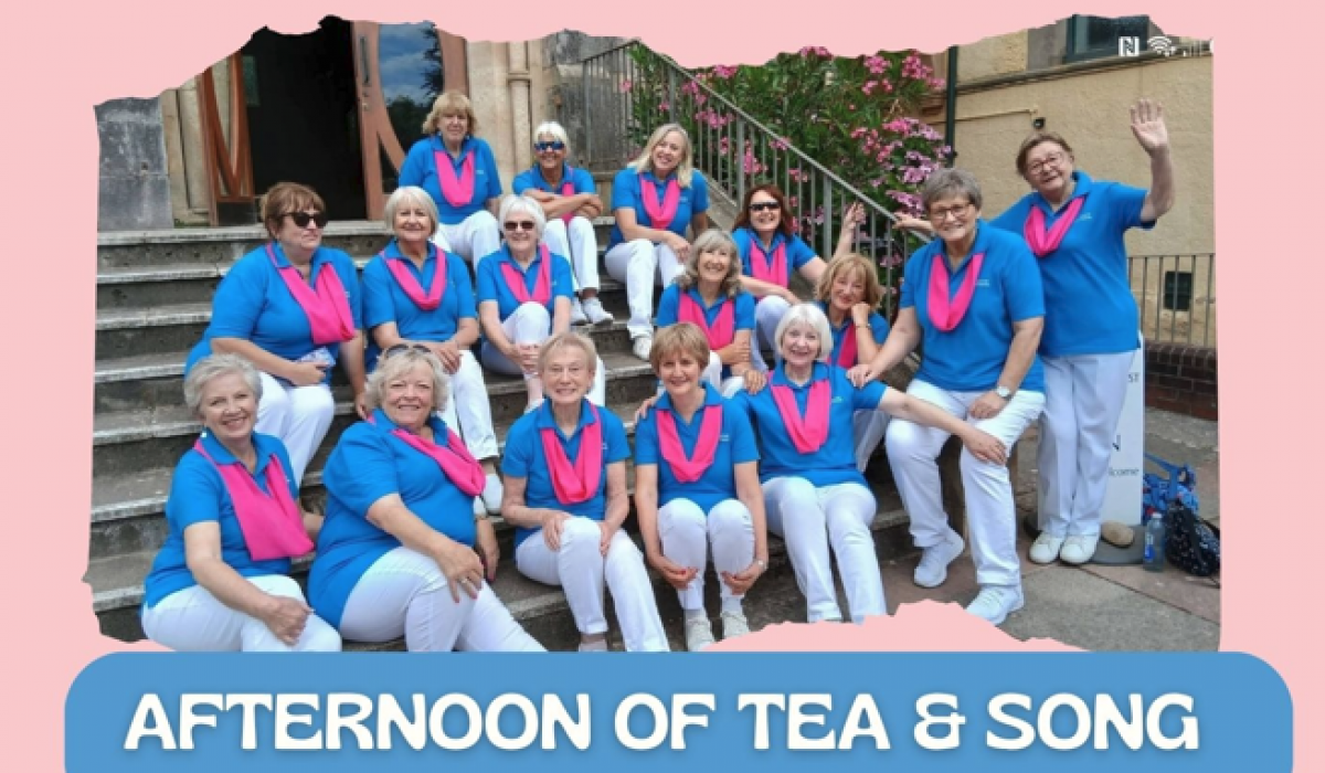 Group photo of the Exmouth A Cappella Choir members sat on steps