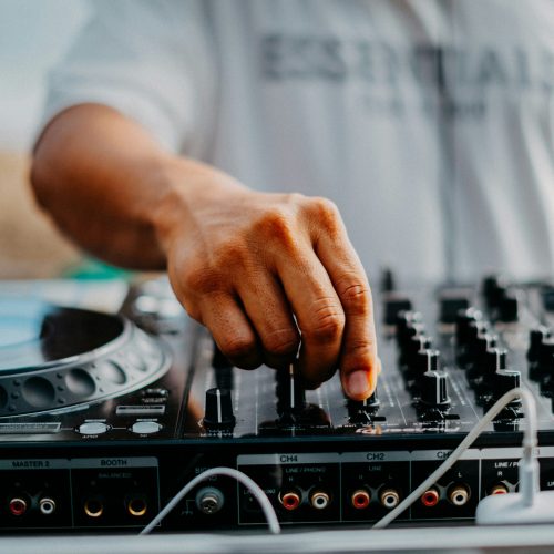 Man adjusting sound levels on a record deck.