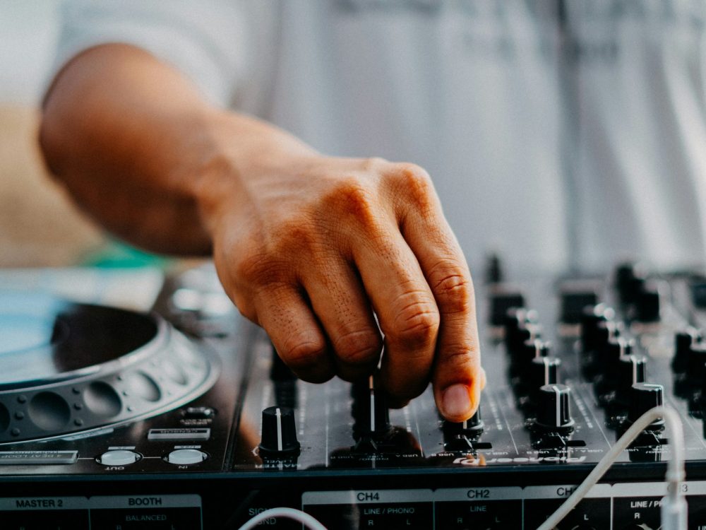 Man adjusting sound levels on a record deck.