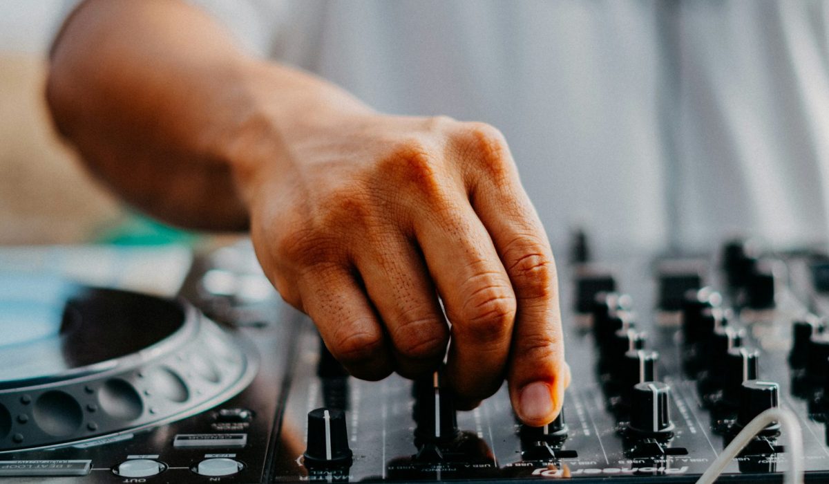 Man adjusting sound levels on a record deck.