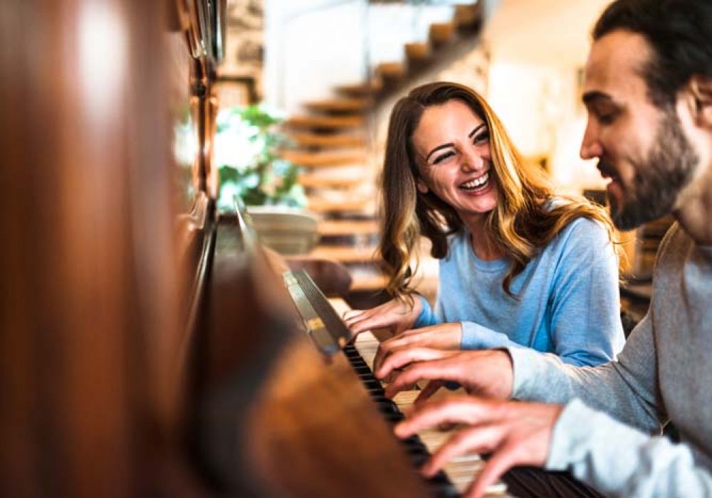 french couple playing the piano in a parisen house