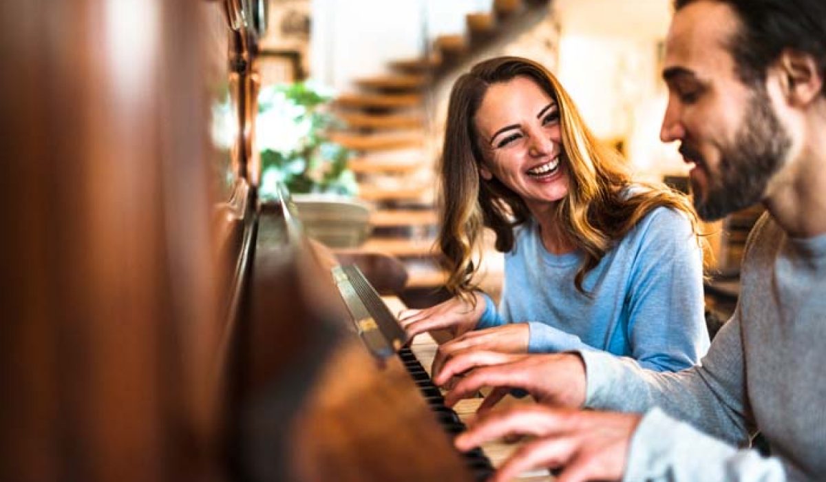 french couple playing the piano in a parisen house
